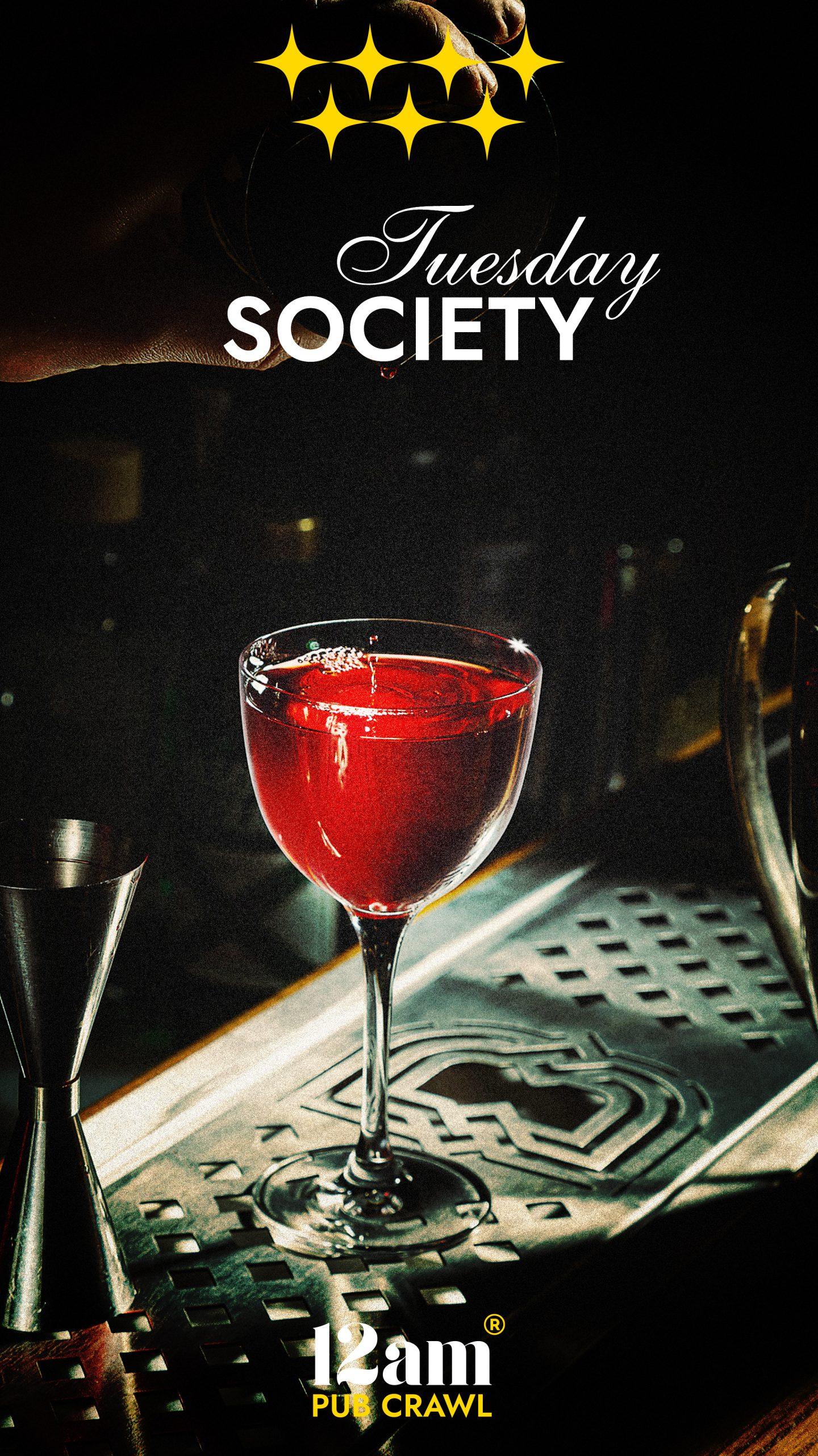 Tuesday Society Madrid Pub Crawl flyer featuring a vibrant red cocktail on a bar counter, with four gold stars and '12am Pub Crawl' logo. Experience Madrid's best Tuesday nightlife.